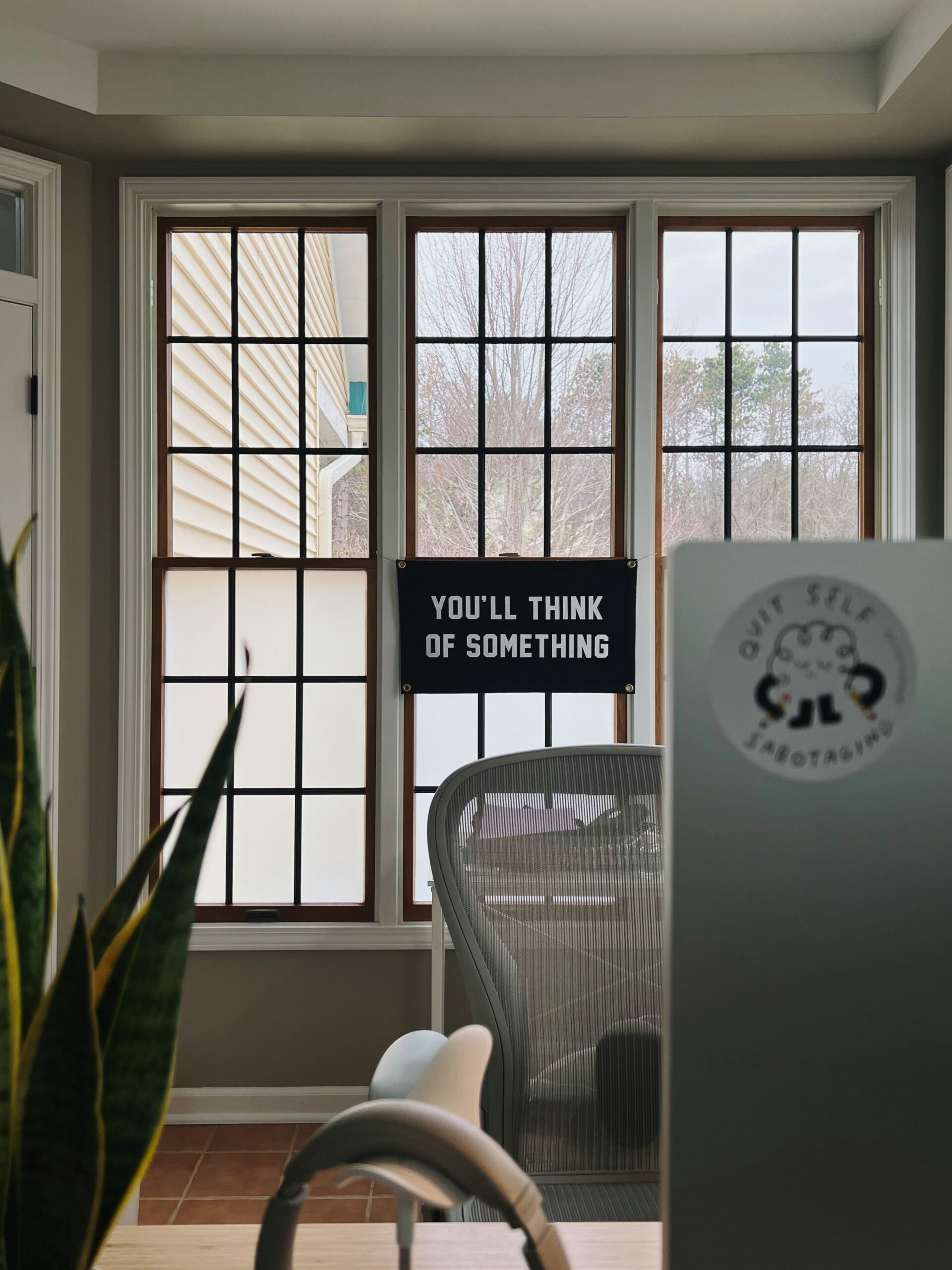Empty chair in an office with a sign that says you'll think of something
